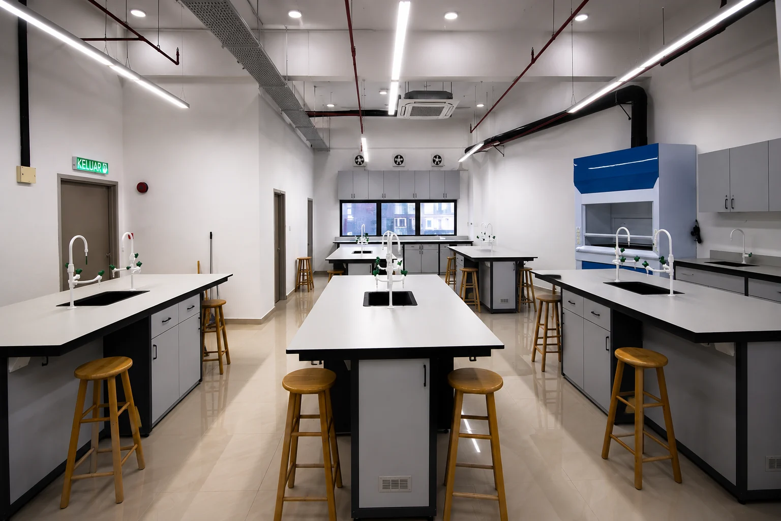Completed training laboratory interior with island benches, sink fixtures and a fume hood.