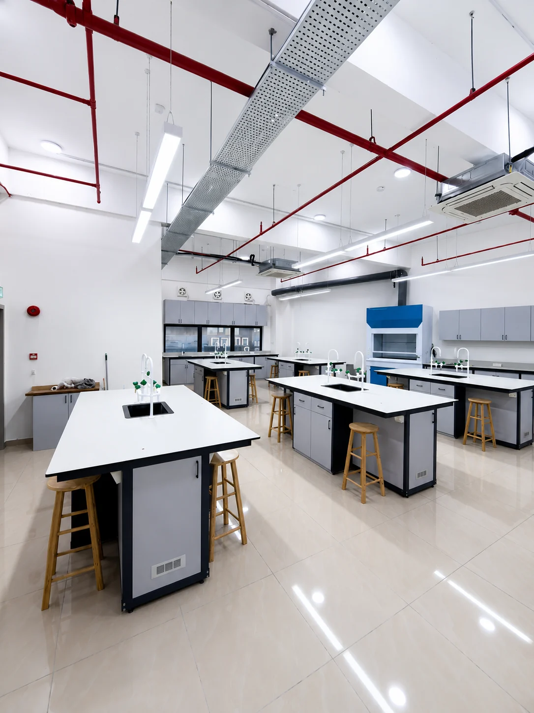 Modern laboratory benches installed in a bright technical laboratory interior.